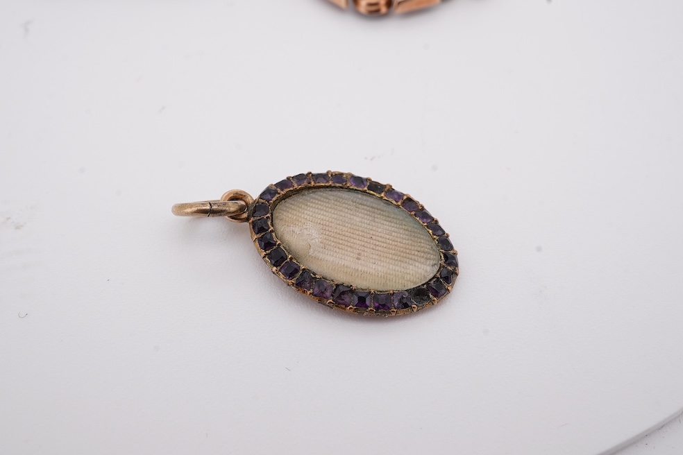 Three assorted Victorian brooches including a 9ct and garnet cluster by Murrle Bennett & Co, 27mm, a micro mosaic bar brooch and a yellow metal and split pearl mourning brooch, together with a gem set oval pendant. Condi
